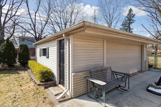 detached garage featuring fence