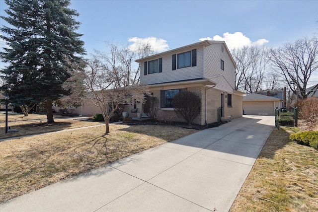 traditional-style house featuring a garage, brick siding, an outdoor structure, and a front yard