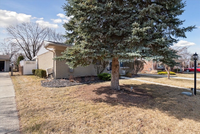 view of side of home featuring brick siding