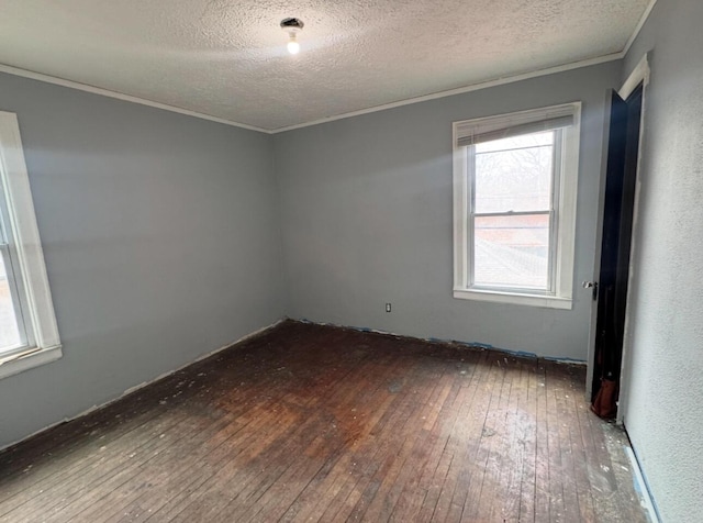 spare room featuring ornamental molding, a textured ceiling, and hardwood / wood-style flooring