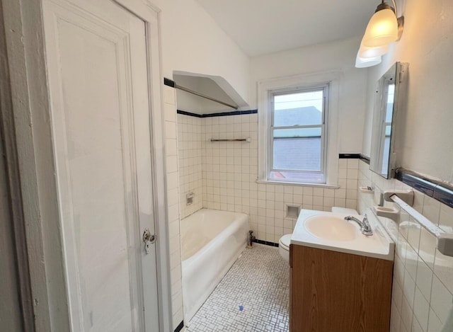 bathroom with vanity, tile walls, toilet, and tile patterned floors