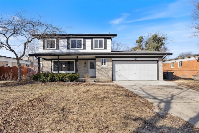 traditional-style home with concrete driveway, an attached garage, fence, and brick siding