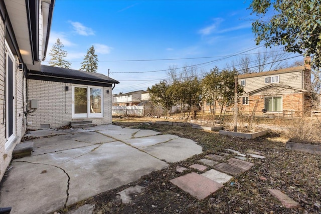 view of yard featuring entry steps, a patio, and fence