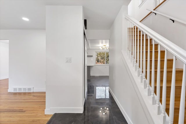 stairs with recessed lighting, wood finished floors, visible vents, and baseboards