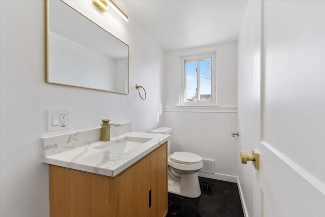 half bath with tile patterned flooring, visible vents, baseboards, toilet, and vanity