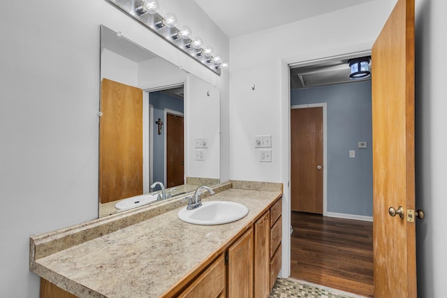 1307 Winston Dr, Jackson, MI 49203 - bathroom featuring baseboards, wood finished floors, and vanity