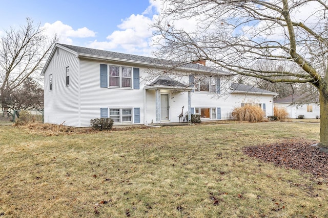 1307 Winston Dr, Jackson, MI 49203 - raised ranch featuring a front lawn and a chimney