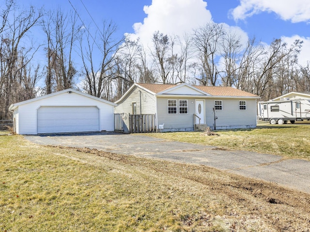 view of front facade featuring an outbuilding, a front lawn, entry steps, fence, and a garage