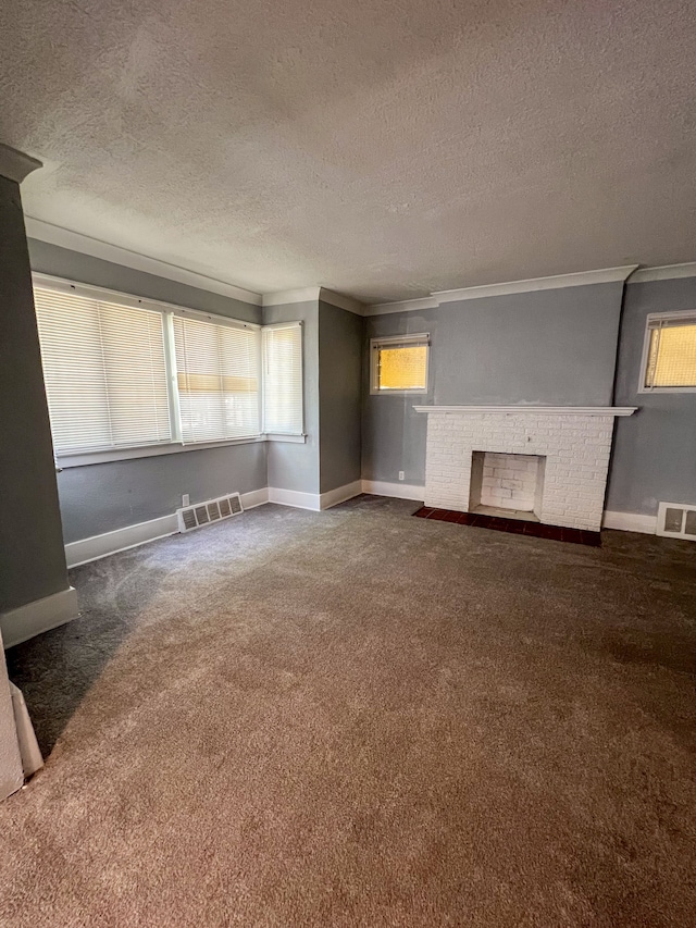 unfurnished living room featuring crown molding, a brick fireplace, carpet flooring, and visible vents