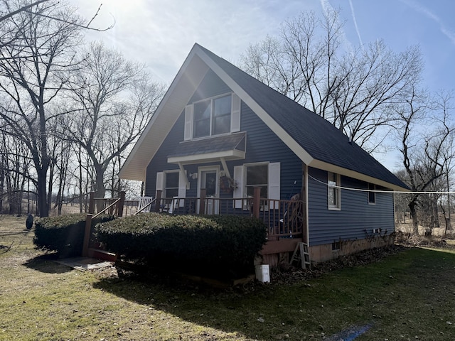 exterior space with a front lawn and roof with shingles