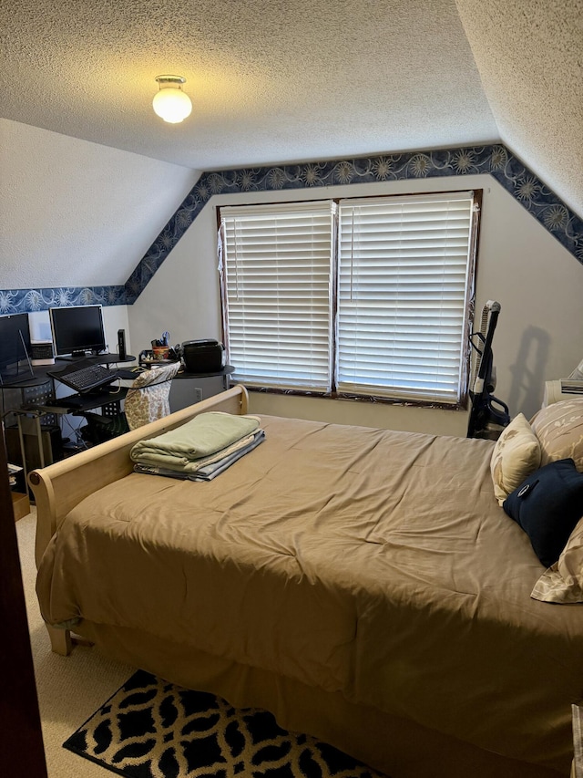 bedroom featuring lofted ceiling and a textured ceiling