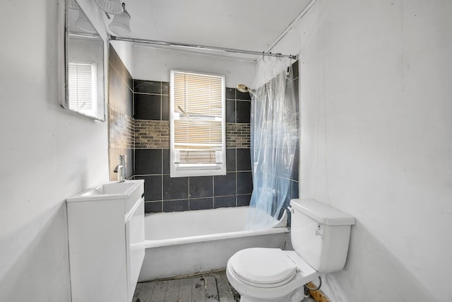 full bath with vanity, toilet, wood finished floors, and shower / bath combo