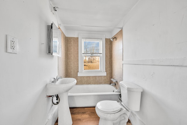 full bathroom featuring toilet, wood finished floors, and shower / bathtub combination