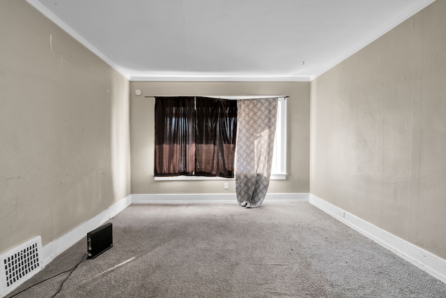 carpeted spare room featuring visible vents, crown molding, and baseboards