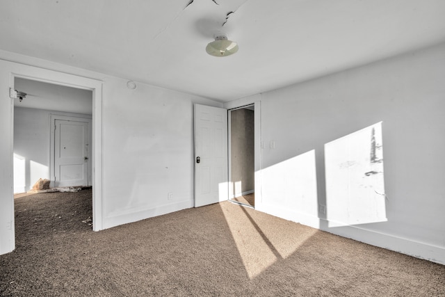 spare room featuring baseboards and carpet floors