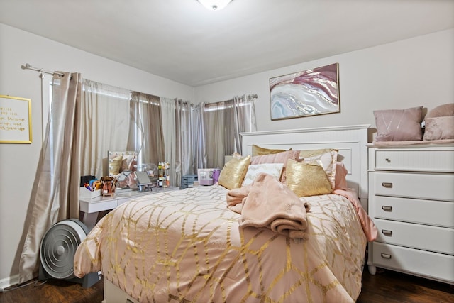 bedroom with dark wood-type flooring