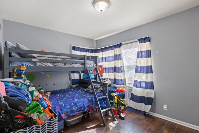 bedroom featuring baseboards and wood-type flooring