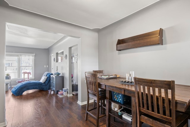 dining area featuring baseboards and wood-type flooring