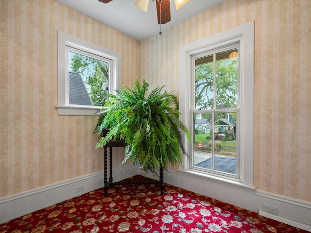 interior space featuring wallpapered walls and a healthy amount of sunlight