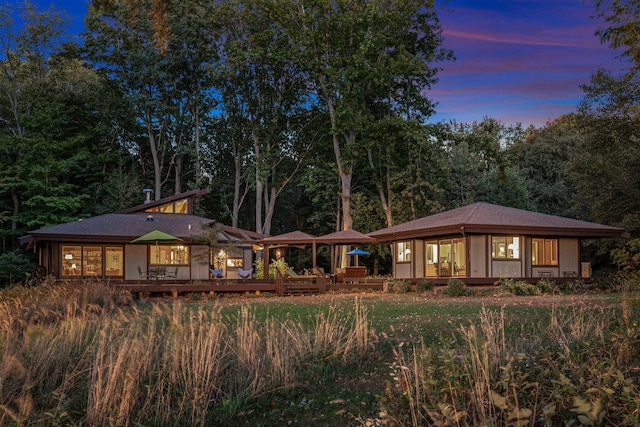 rear view of property featuring a wooden deck