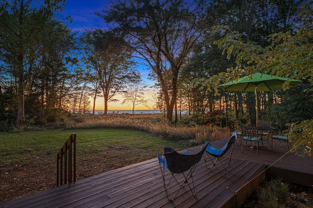 deck at dusk with a lawn