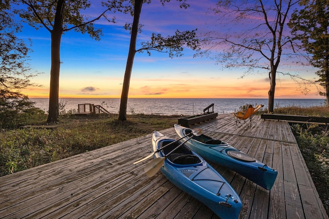 view of dock with a deck with water view