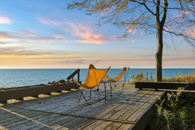 wooden terrace featuring a water view