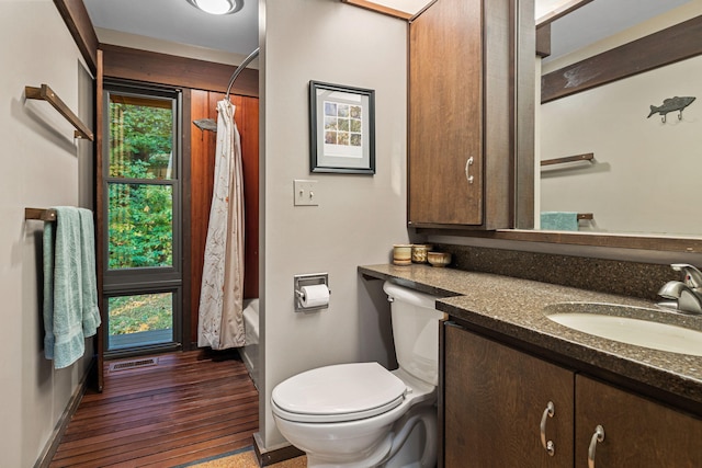 bathroom with vanity, toilet, visible vents, and plenty of natural light