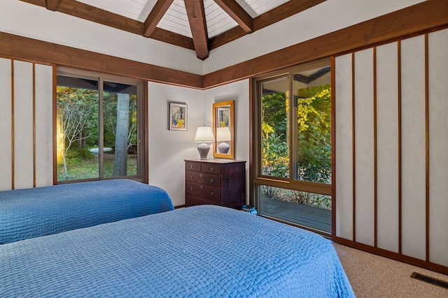 carpeted bedroom featuring beamed ceiling and visible vents