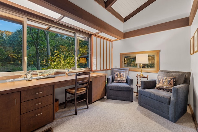 office space with light carpet, lofted ceiling, and built in study area