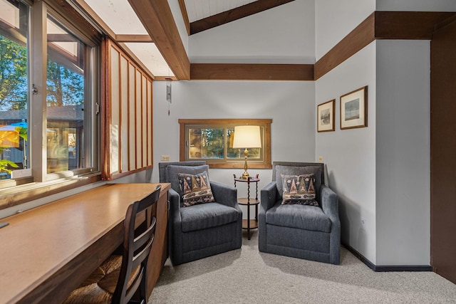 living area with lofted ceiling with beams, carpet, and baseboards