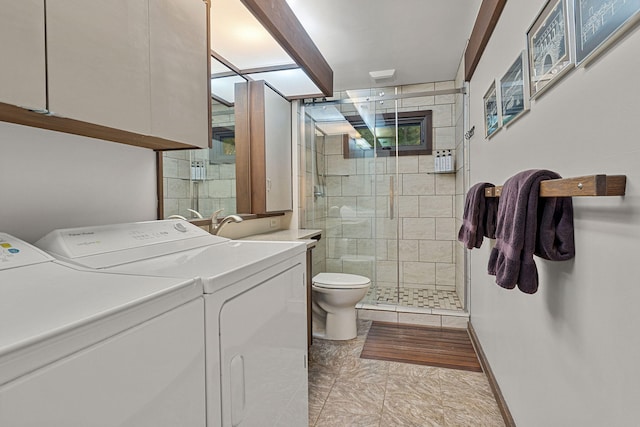 full bathroom featuring vanity, a shower stall, toilet, and washing machine and clothes dryer