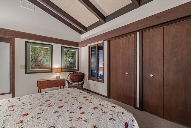 bedroom featuring vaulted ceiling with beams, carpet, visible vents, and multiple closets