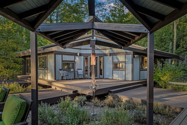 rear view of property with a wooden deck