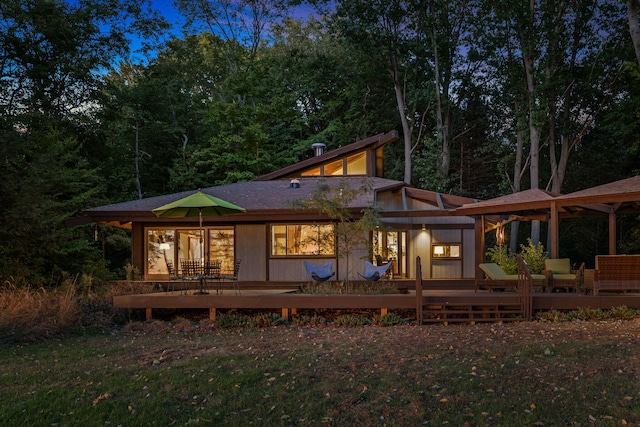 rear view of property featuring a deck