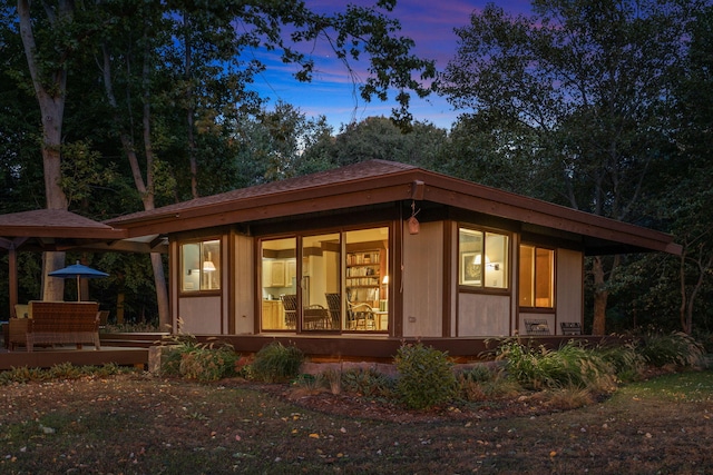 view of back of property at dusk