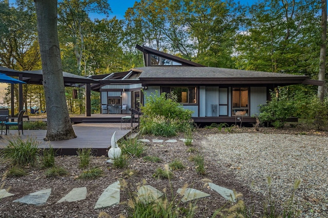 back of house with a wooden deck