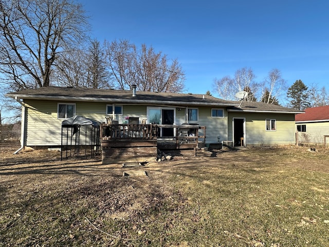 back of house with a wooden deck and a yard