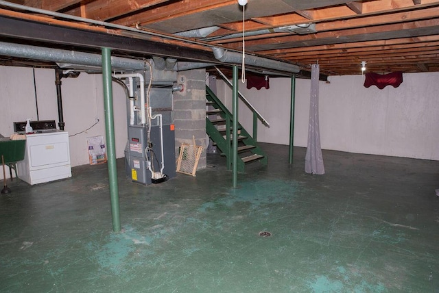 unfinished basement with heating unit, stairway, washer / dryer, and a sink