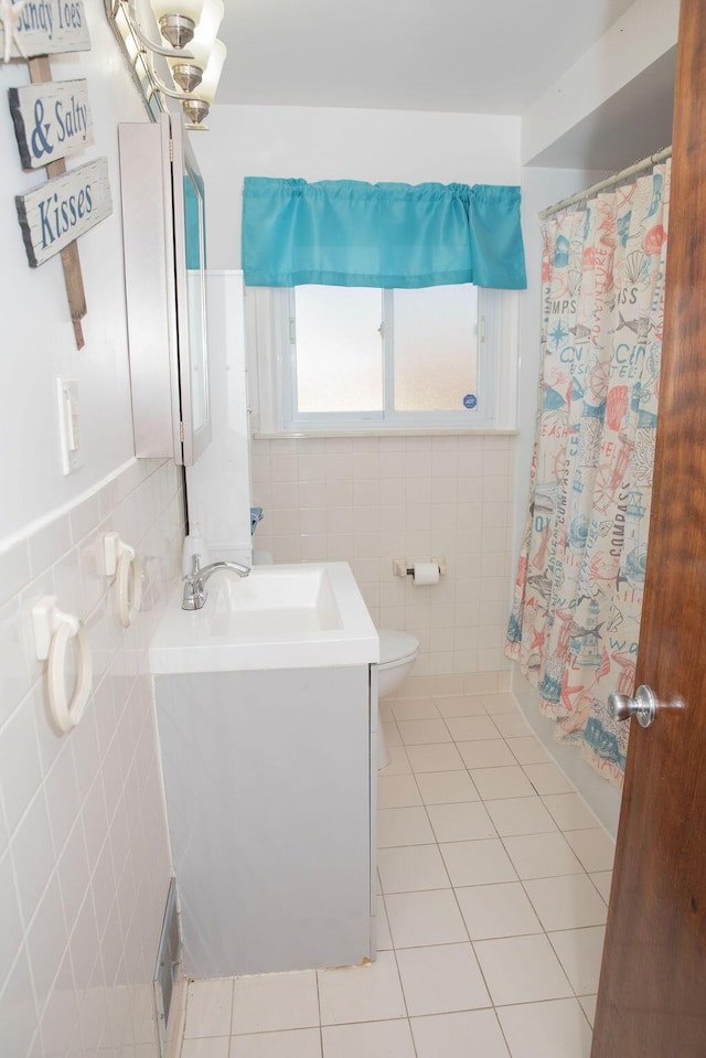 full bath with tile patterned flooring, toilet, tile walls, and vanity