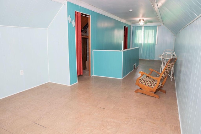 additional living space featuring lofted ceiling and a ceiling fan