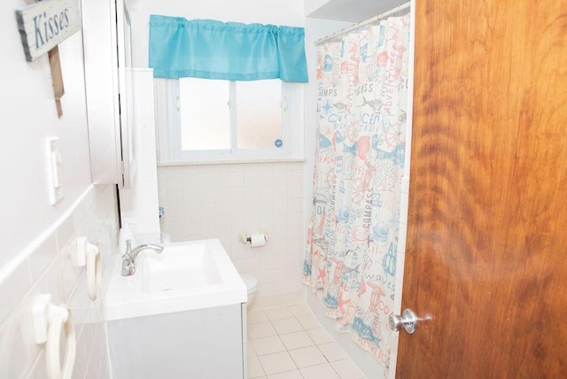 bathroom with vanity, tile patterned floors, and tile walls