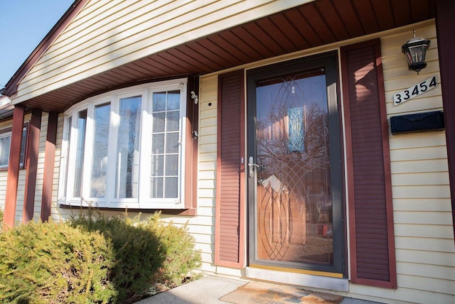 view of exterior entry with covered porch