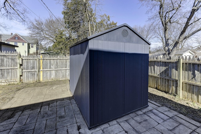 view of shed with a fenced backyard