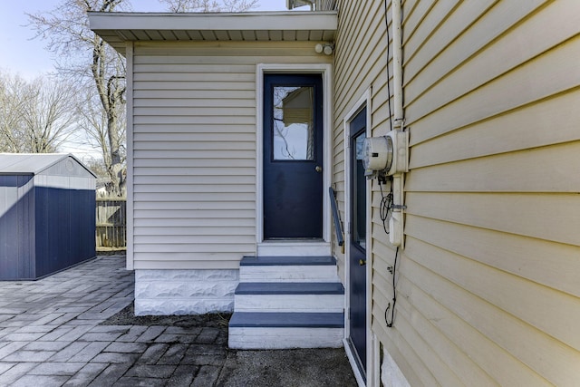 view of exterior entry with a patio