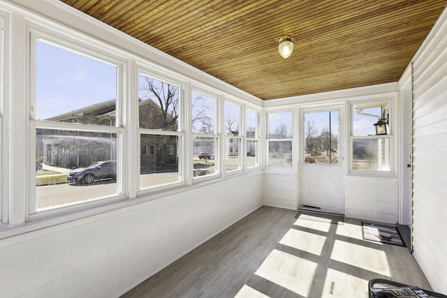 unfurnished sunroom featuring a wealth of natural light and wooden ceiling