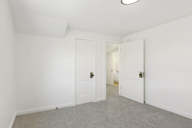 interior space featuring baseboards and carpet floors