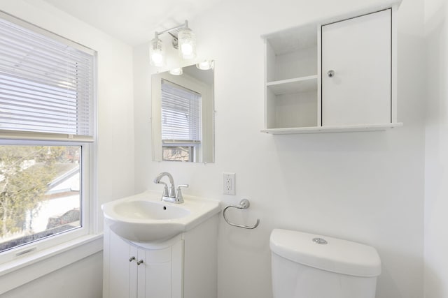 half bathroom featuring toilet and vanity