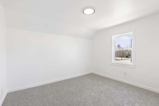 bonus room with lofted ceiling, baseboards, and carpet floors