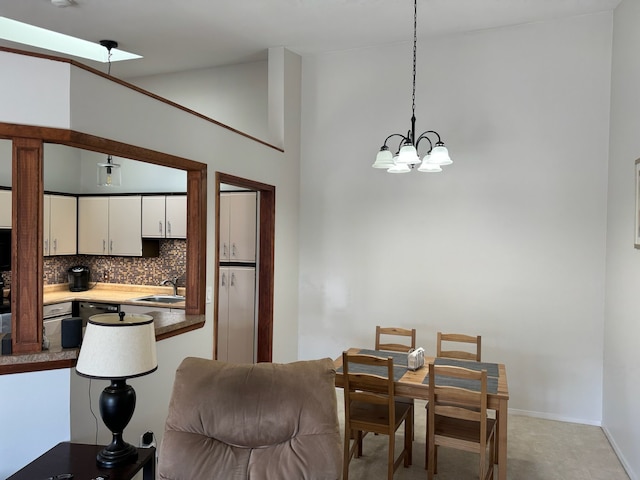 dining area with vaulted ceiling, baseboards, and a chandelier